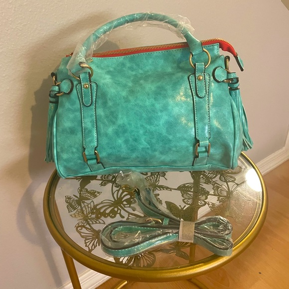Turquoise large faux leather handbag with tassel accents. - Picture 1 of 4